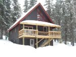 Alpine Retreat - Front view of cabin in the winter. 